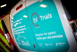 Rear of an electric van with an advert for the Highways England EV trial