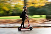Woman on a Voi e-scooter